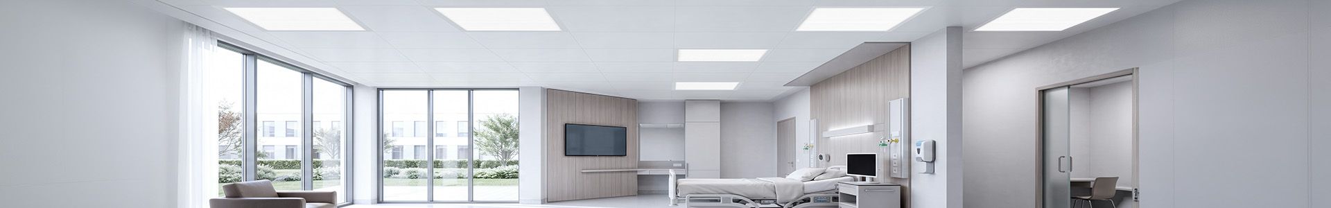 A hospital corridor with a bed and a window, highlighting the importance of appropriate lighting in healthcare facilities | Lumedic
