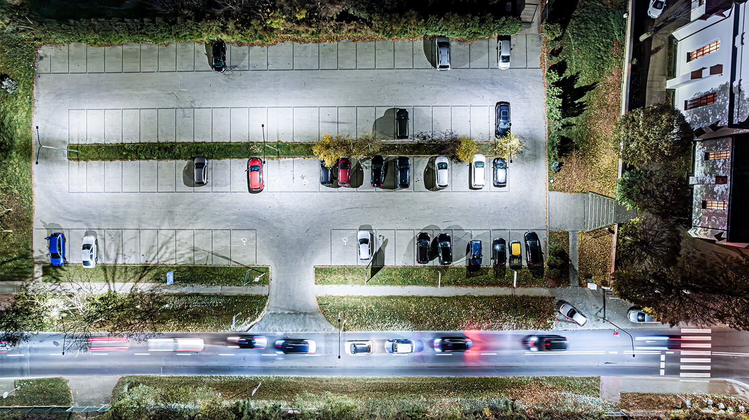  A view of a car park with vehicles, highlighting the role of lighting fittings in ensuring safety and functionality.