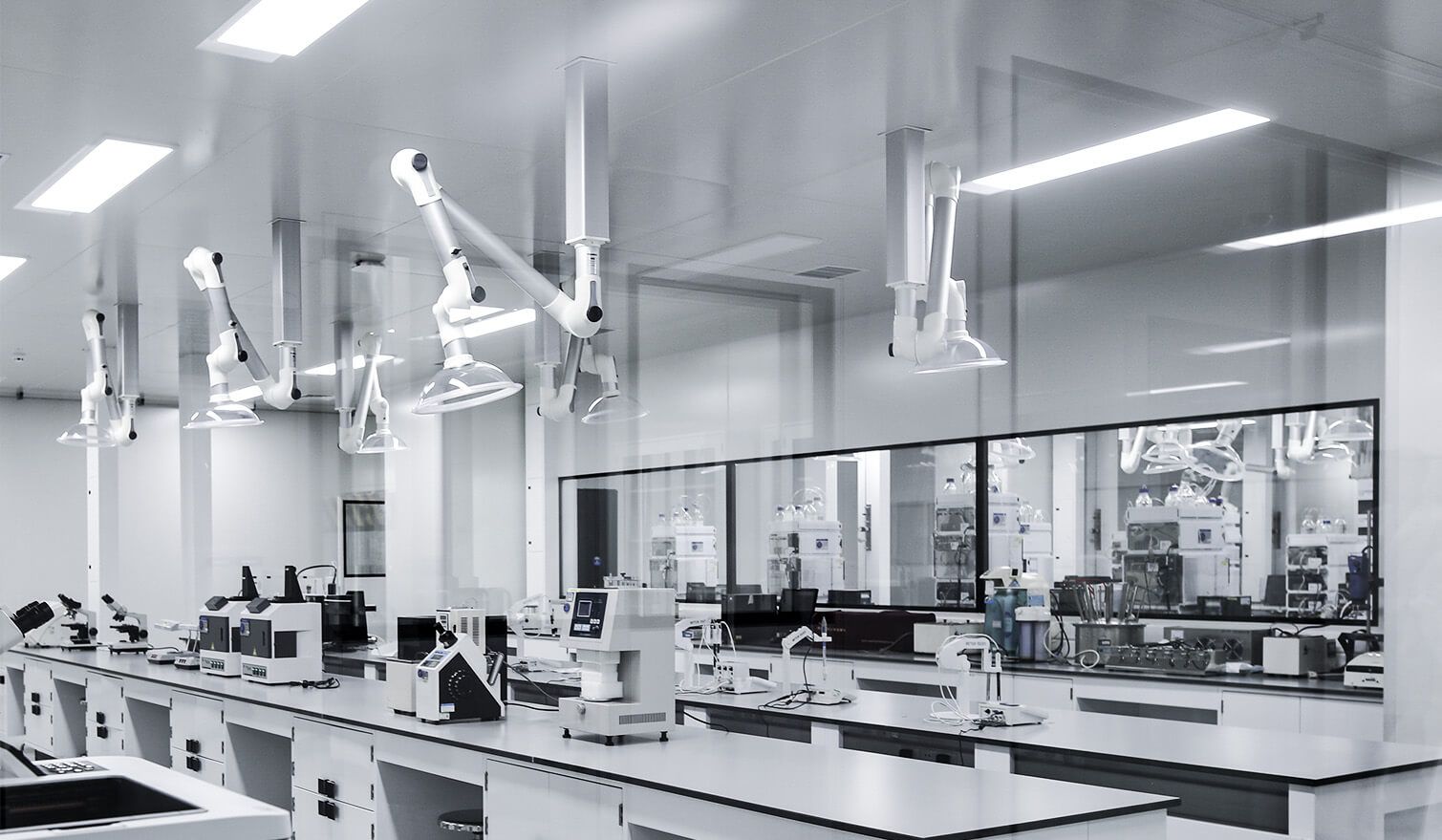 A laboratory with white walls, modern equipment and lighting, designed for the pharmaceutical industry